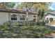 Lovely home exterior featuring a well-manicured lawn, large window, and ample greenery at 2009 Halidom Way, Sun City Center, FL 33573