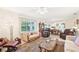 Spacious living room with large windows, comfortable seating, and views of the outdoors at 2009 Halidom Way, Sun City Center, FL 33573