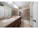 Bathroom featuring a double sink vanity, large mirror, and glass-enclosed shower at 2011 Hawks View Dr, Ruskin, FL 33570