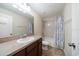 This well-lit bathroom includes a vanity with a sink, toilet and shower with tub combination at 2011 Hawks View Dr, Ruskin, FL 33570