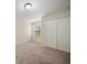 This simply decorated bedroom has carpeting, a window with blinds, and a double-door closet at 2011 Hawks View Dr, Ruskin, FL 33570
