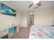 This cozy bedroom features a ceiling fan, TV, fun storage, and is decorated with a beach theme at 2011 Hawks View Dr, Ruskin, FL 33570