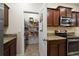 Kitchen view with a large pantry filled with storage; granite countertops and stainless steel appliances at 2011 Hawks View Dr, Ruskin, FL 33570