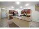 Kitchen with granite countertops, stainless appliances, large island, and nearby entry door at 2011 Hawks View Dr, Ruskin, FL 33570