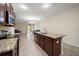 Open-concept kitchen with granite countertops and island overlooks the spacious living room at 2011 Hawks View Dr, Ruskin, FL 33570