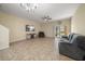 Spacious living room with neutral walls, ceiling fan, tile floors, and a sliding glass door at 2011 Hawks View Dr, Ruskin, FL 33570