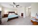 Spacious main bedroom with a ceiling fan, carpeted floors, and neutral walls at 2011 Hawks View Dr, Ruskin, FL 33570