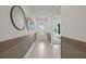 Stylish hallway with decorative mirrors and views into the entry and a bedroom at 2333 Candlebrook Path, North Port, FL 34289