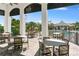 A covered patio seating area offers views of the community's resort-style pool and landscaping at 2637 Butterfly Jasmine Trl, Sarasota, FL 34240