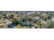 Aerial view of a home with a lush green yard, mature trees, and located near a body of water in a quiet neighborhood at 311 Ravenna N St, Nokomis, FL 34275