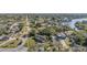 Charming home with vibrant green lawn and mature trees, nestled in a peaceful neighborhood near a body of water at 311 Ravenna N St, Nokomis, FL 34275