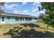 Backyard features healthy grass, a fire pit and the home's rear windows at 311 Ravenna N St, Nokomis, FL 34275