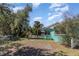 Backyard with healthy grass, white picket fence, and nice trees at 311 Ravenna N St, Nokomis, FL 34275