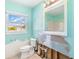 Bathroom with toilet, window with view, and exposed plumbing at 311 Ravenna N St, Nokomis, FL 34275