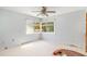 Bedroom with sunlit windows offering bright natural light and a neutral color palette at 311 Ravenna N St, Nokomis, FL 34275