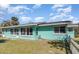 Exterior of the home, with large windows, well maintained grass, and secure fencing at 311 Ravenna N St, Nokomis, FL 34275