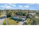 Charming one-story home with light blue exterior, green grass and palm trees at 311 Ravenna N St, Nokomis, FL 34275
