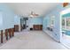 Spacious living room with aqua walls and damaged trim at 311 Ravenna N St, Nokomis, FL 34275