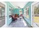 Sunroom with windows, ceiling fan, seating, and neutral colored walls at 311 Ravenna N St, Nokomis, FL 34275