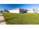 The spacious backyard with lush green lawn offers a serene outdoor space for relaxation and entertainment at 31399 Penny Surf Loop, Wesley Chapel, FL 33545