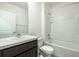 This bathroom boasts a shower/tub combo, granite vanity and tile floor at 31399 Penny Surf Loop, Wesley Chapel, FL 33545