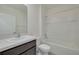 Modern bathroom with white vanity, granite countertop, and a tub-shower combination at 31399 Penny Surf Loop, Wesley Chapel, FL 33545