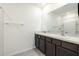 This bathroom has a double vanity, a mirror, and a tub/shower combo at 31399 Penny Surf Loop, Wesley Chapel, FL 33545