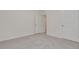 Neutral bedroom with door to closet area; emphasis on size of room and neutral color palette at 31399 Penny Surf Loop, Wesley Chapel, FL 33545