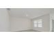 Bright bedroom with neutral walls, tile floors, large window, and recessed lighting at 31399 Penny Surf Loop, Wesley Chapel, FL 33545