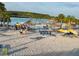 Expansive community lagoon beach featuring thatched umbrellas and recreational space for homeowners at 31399 Penny Surf Loop, Wesley Chapel, FL 33545