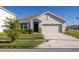 Charming single-Gathering home with a well-maintained lawn and attached two-car garage at 31399 Penny Surf Loop, Wesley Chapel, FL 33545