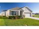 Charming one-story home featuring a well-manicured lawn, tasteful landscaping, and an attached two-car garage at 31399 Penny Surf Loop, Wesley Chapel, FL 33545