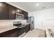 Modern kitchen with stainless steel appliances, granite countertops, and sleek cabinetry at 31399 Penny Surf Loop, Wesley Chapel, FL 33545