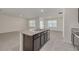 Spacious kitchen island with granite countertops and a modern sink set against an open floor plan at 31399 Penny Surf Loop, Wesley Chapel, FL 33545