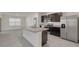 Contemporary kitchen with stainless appliances, an island with granite countertops, and lots of light at 31399 Penny Surf Loop, Wesley Chapel, FL 33545