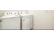 This laundry room contains a Whirlpool washer and dryer at 31399 Penny Surf Loop, Wesley Chapel, FL 33545
