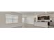 Open-concept living room featuring tile floors, natural light, and a view of the kitchen at 31399 Penny Surf Loop, Wesley Chapel, FL 33545