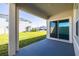 Covered outdoor patio with a large sliding glass door is perfect for relaxing and enjoying the backyard view at 31399 Penny Surf Loop, Wesley Chapel, FL 33545