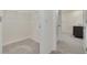 Bright walk-in closet with metal shelving and plush gray carpeting; leads to bathroom with granite vanity top at 31399 Penny Surf Loop, Wesley Chapel, FL 33545