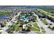 Aerial view of neighborhood featuring a pool, park, basketball court, and mature trees at 31730 Spoonflower Cir, Wesley Chapel, FL 33545