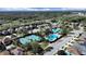 Aerial view of community pool, tennis courts, and neighborhood at 31730 Spoonflower Cir, Wesley Chapel, FL 33545