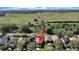 Aerial view of home backing to a greenbelt and a field with blue skies above at 31730 Spoonflower Cir, Wesley Chapel, FL 33545