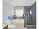 Bathroom with modern tiling, shower, and jetted tub at 31730 Spoonflower Cir, Wesley Chapel, FL 33545