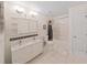 Bright bathroom featuring a double sink vanity, tiled floors, and shower-tub combo at 31730 Spoonflower Cir, Wesley Chapel, FL 33545