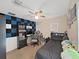 Cozy bedroom with gaming setup, ceiling fan, and space saving furniture at 31730 Spoonflower Cir, Wesley Chapel, FL 33545