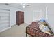 Bedroom featuring a ceiling fan, a built in bookshelf, and plenty of space at 31730 Spoonflower Cir, Wesley Chapel, FL 33545