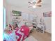 Bright bedroom with a ceiling fan and natural light from the large windows at 31730 Spoonflower Cir, Wesley Chapel, FL 33545