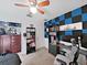 Bedroom with unique blue and black padded wall, shelving, and ceiling fan at 31730 Spoonflower Cir, Wesley Chapel, FL 33545