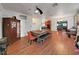 Open concept dining room with hardwood floors, modern lighting, and a built in hutch at 31730 Spoonflower Cir, Wesley Chapel, FL 33545