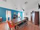 Dining room featuring a large table with wooden top, and a blue accent wall at 31730 Spoonflower Cir, Wesley Chapel, FL 33545